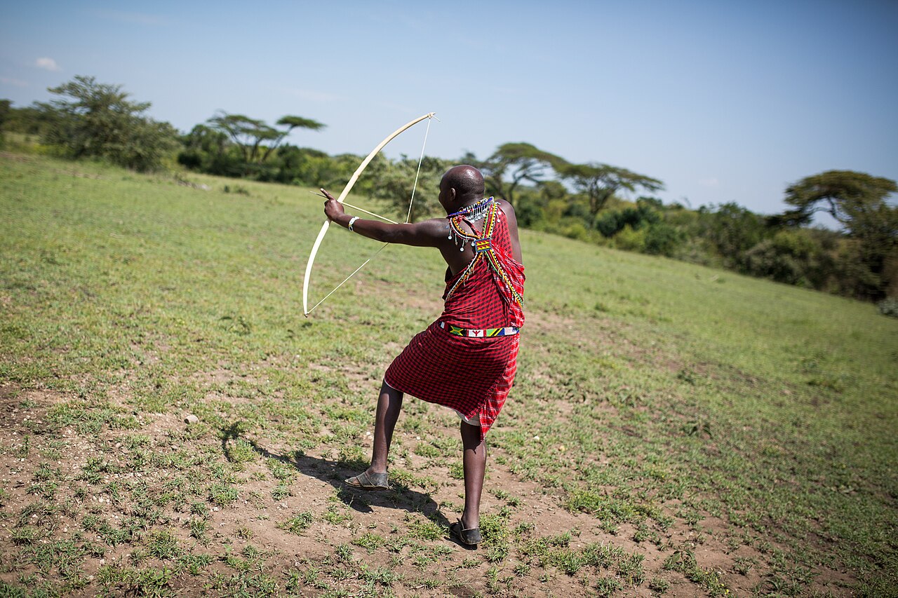 Maasai guide in the Mara representing the Maasai Mara National Reserve tourism economy