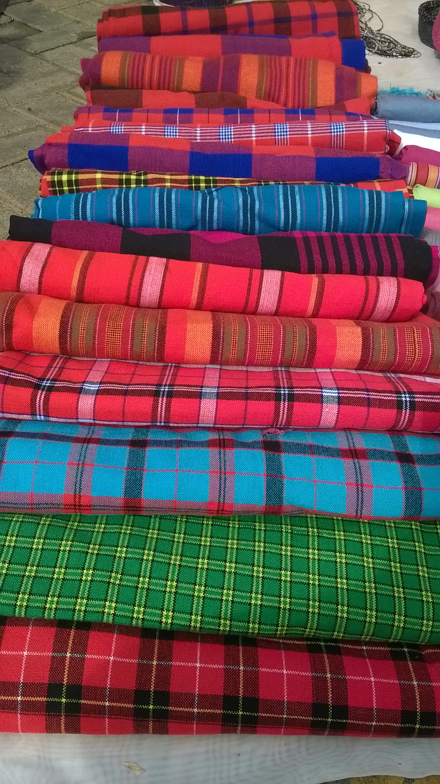 Colourful textiles on display at an open-air market in Nairobi, Kenya, evoking the bustling trade of Gikomba